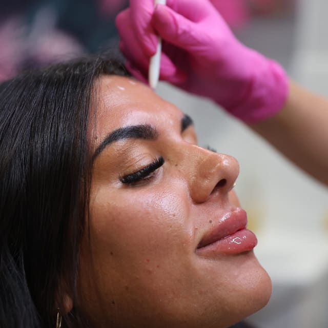 A client having the brow area prepared before a facial treatment